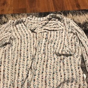 A long sleeve shirt with flowers going up and down in a designed pattern